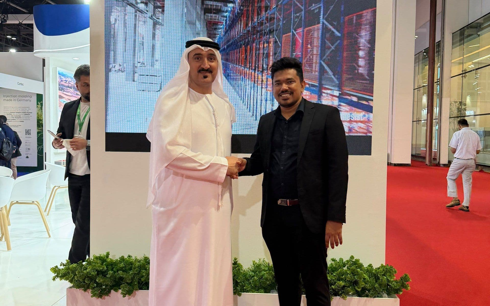 ABWAB Holdings and Storygame leadership shaking hands at a Dubai exhibition